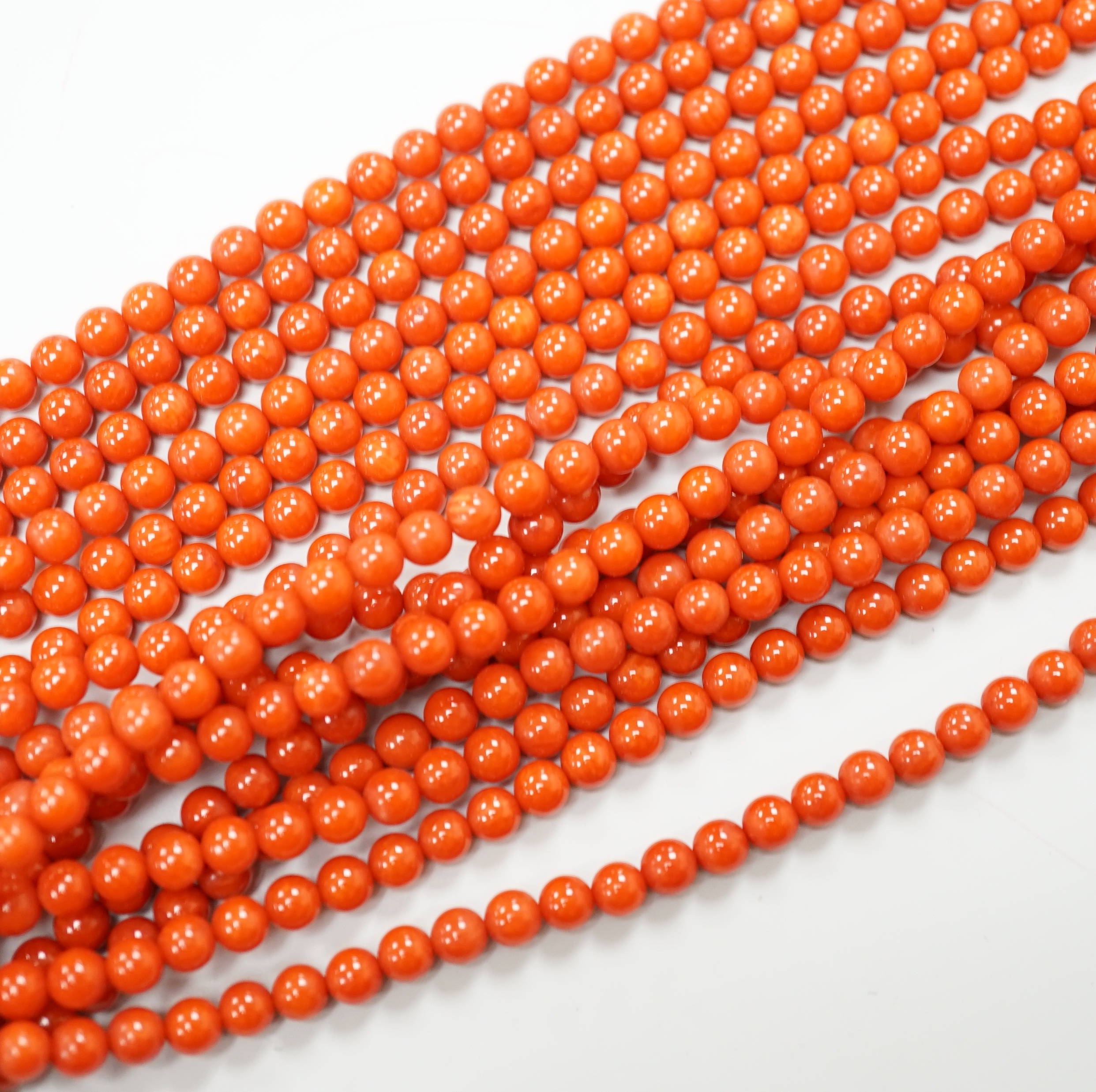 A 1980's Italian multi strand coral bead necklace, with 750 yellow metal clasp and Certificate of Authenticity, 50cm.